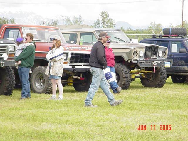 Red pickup truck with lifted suspension and large tires