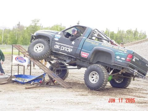 1978 Ford Bronco - A heavily modified Dodge pickup truck navigates an off-road obstacle course, with the date June 11, 2005 visible.