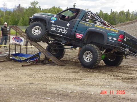 1978 Ford Bronco - A heavily modified Dodge pickup truck navigates an obstacle course, as indicated by the "KODIAK OFF-ROAD" decal.