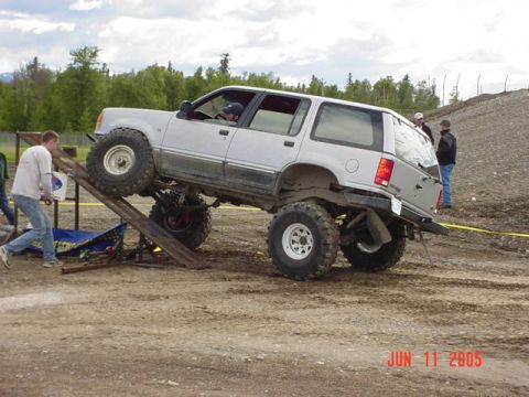 1978 Ford Bronco - Modified SUV with oversized tires attempts an obstacle on a ramp during an event in 2005.