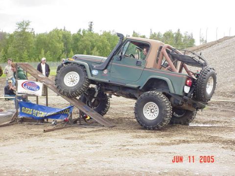 1978 Ford Bronco - A modified Jeep Wrangler navigates an off-road obstacle course during an event in June 2005.