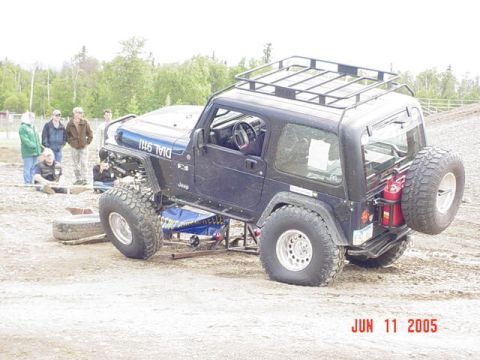 1978 Ford Bronco - Modified Jeep Wrangler with "DIAL 911" on the hood and a spare tire mounted on the rear carrier.