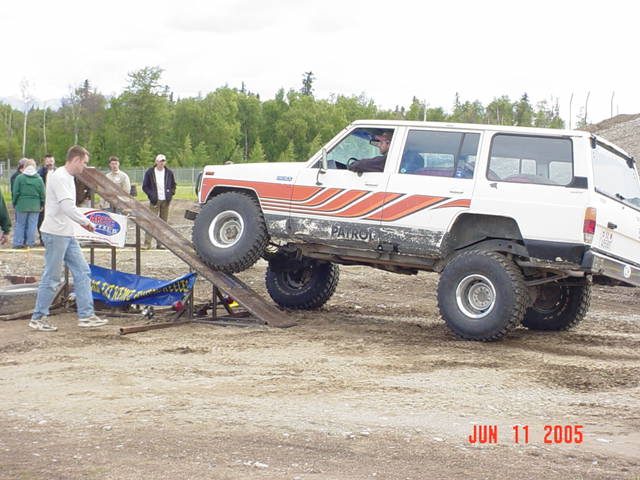 White SUV with orange stripes on a ramp, "PATROL" text visible