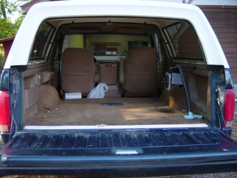 1991 Ford Bronco - Rear view of a 1991 Ford Bronco showing the cargo space and front seats.