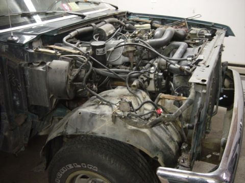 1991 Ford Bronco - The engine bay of a 1991 Ford Bronco shows significant disassembly, revealing its internal components.