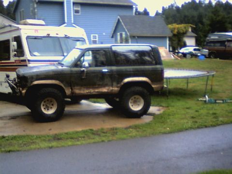 1987 Ford Bronco II - This 1987 Ford Bronco II is shown in a side profile, off-road tires and a weathered exterior.