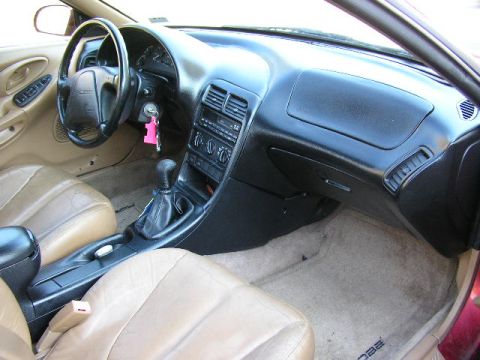 1994 Ford Probe - Interior view of a 1994 Ford Probe, showing tan seats and a black dashboard with a manual shifter.