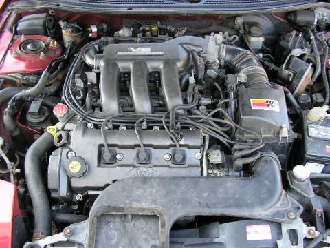 1994 Ford Probe - The engine bay of a vehicle, a V6 engine and a K&N air filter, is shown in this image.
