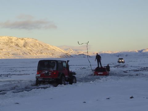 2001 Jeep Wrangler - Multiple Jeeps are stuck in a snowy landscape, with people attempting to free them.