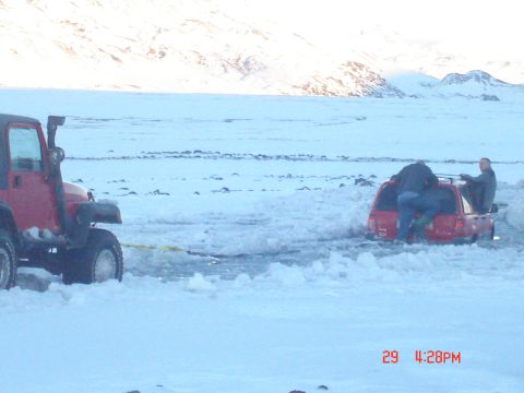 2001 Jeep Wrangler - Two red Jeeps in a snowy landscape, one assisting the other out of a snowdrift.
