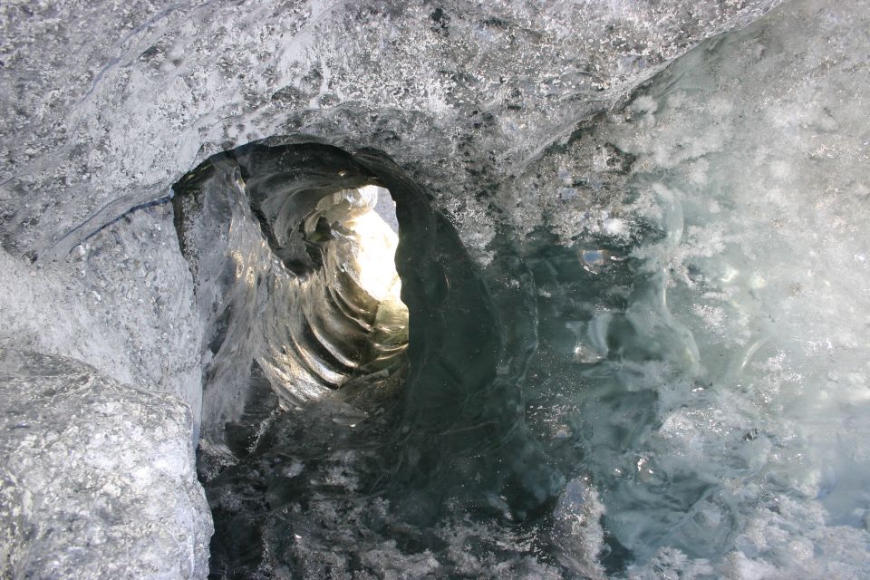 Opening in an ice cave with light shining through