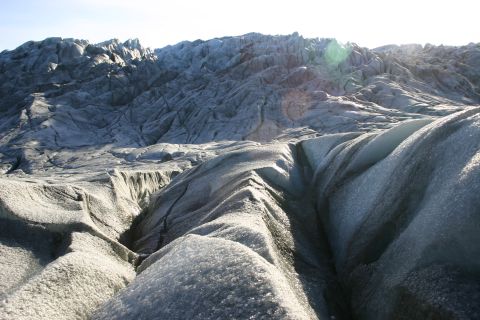 2003 Jeep TJ - A vast glacier landscape under a clear sky, with intricate ice formations and distant mountain ranges.