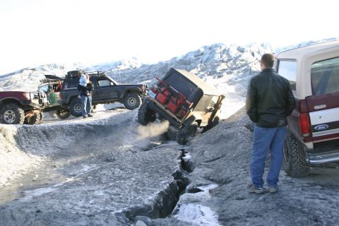 2003 Jeep TJ - Off-road vehicles traverse a glacial landscape with visible cracks in the ice.
