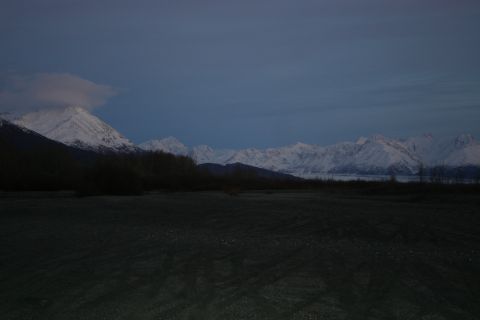 2003 Jeep TJ - A vast expanse of snow-capped mountains dominates the horizon under a dusky blue sky.