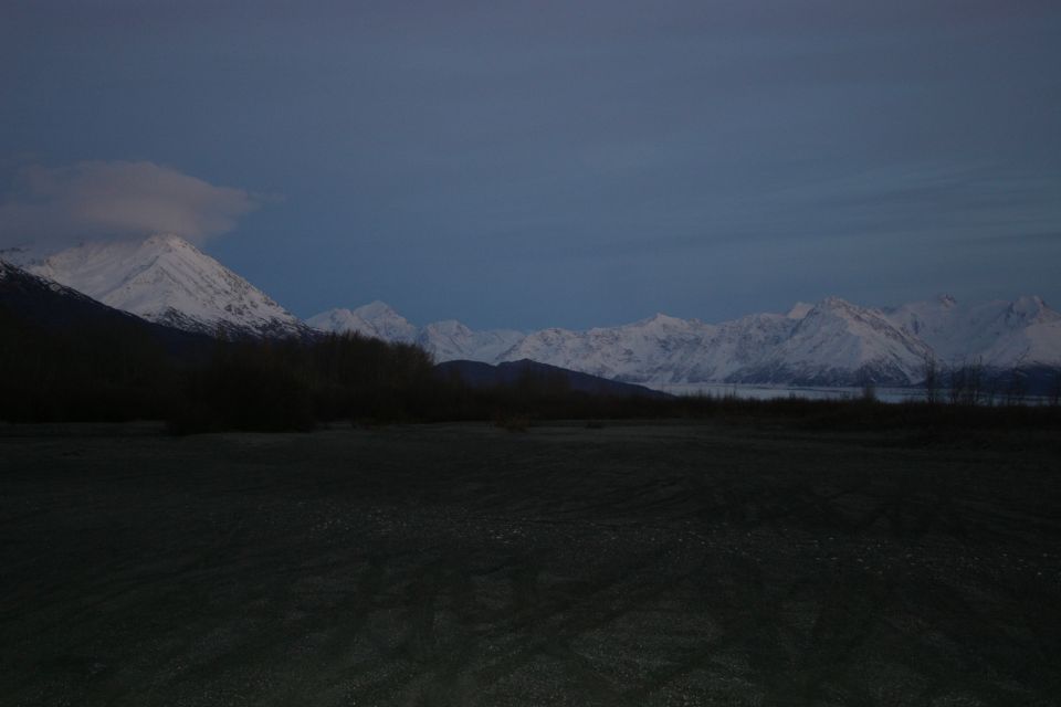 Snowy mountain range under a twilight sky