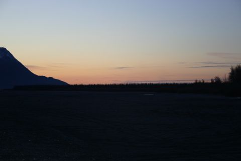 2003 Jeep TJ - A vast landscape with a mountain silhouette against a colorful twilight sky.