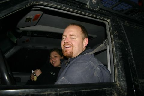 2003 Jeep TJ - Two people are inside a vehicle, possibly on an off-road adventure.