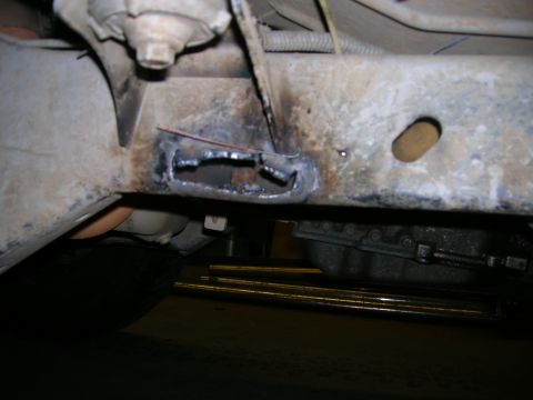 2003 Jeep TJ - Vehicle frame section showing modifications with cutouts and welding.