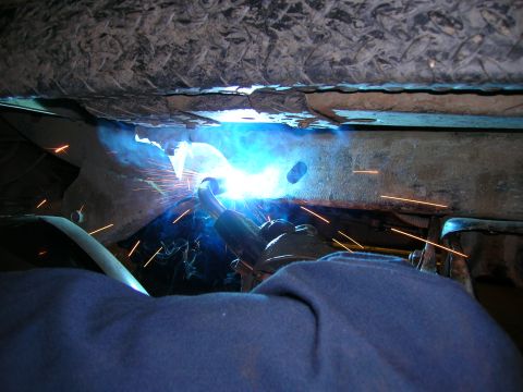 2003 Jeep TJ - Welding sparks fly as a frame is cut into.