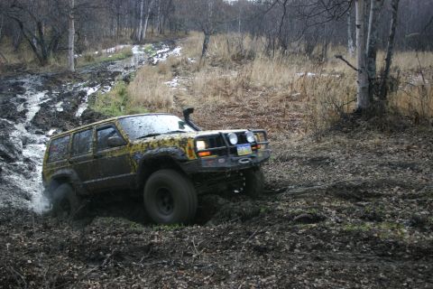 2003 Jeep TJ - Jeep Cherokee XJ navigates a muddy trail with a snorkel installed.