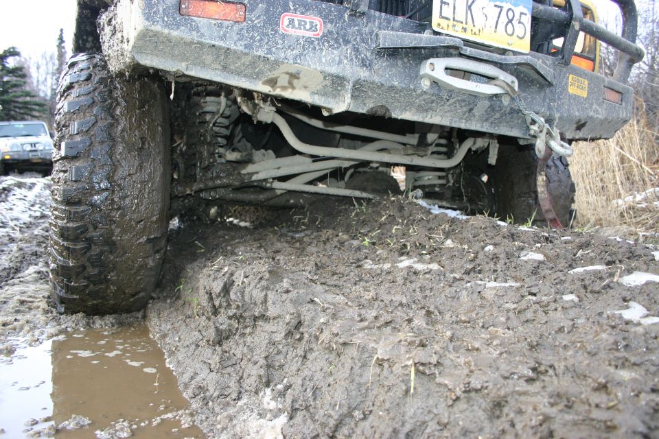 2003 Jeep TJ rear axle stuck in mud, license plate ELK 785 visible