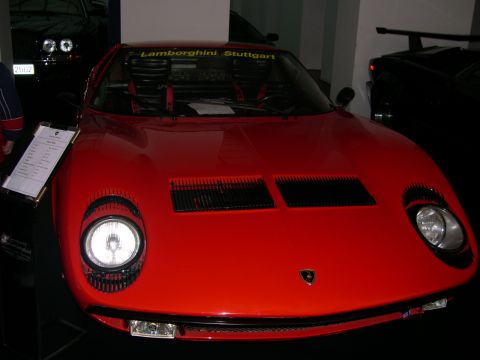 2003 Jeep TJ - A red Lamborghini Miura is displayed with a sign detailing its specifications.