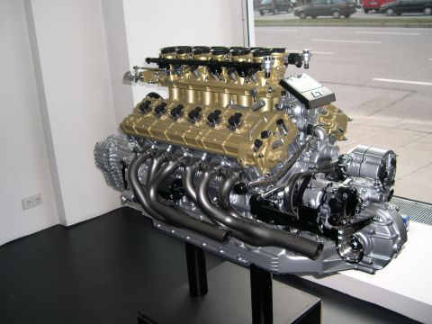 2003 Jeep TJ - A powerful V12 engine is showcased, likely for an exotic car, with its intricate components visible.