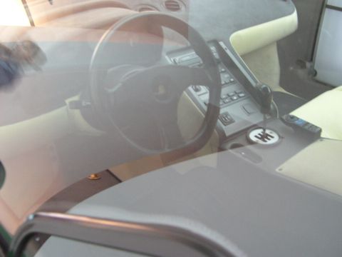 2003 Jeep TJ - Car interior details including steering wheel, gear shift, and dashboard elements.