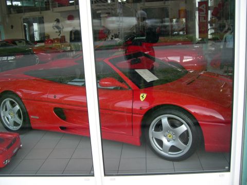 2003 Jeep TJ - Red Ferrari sports car with distinctive side vents and five-spoke wheels.