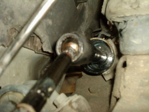 2000 Ford Taurus - Close-up of a vehicle's tie rod end with a socket wrench attached during maintenance.