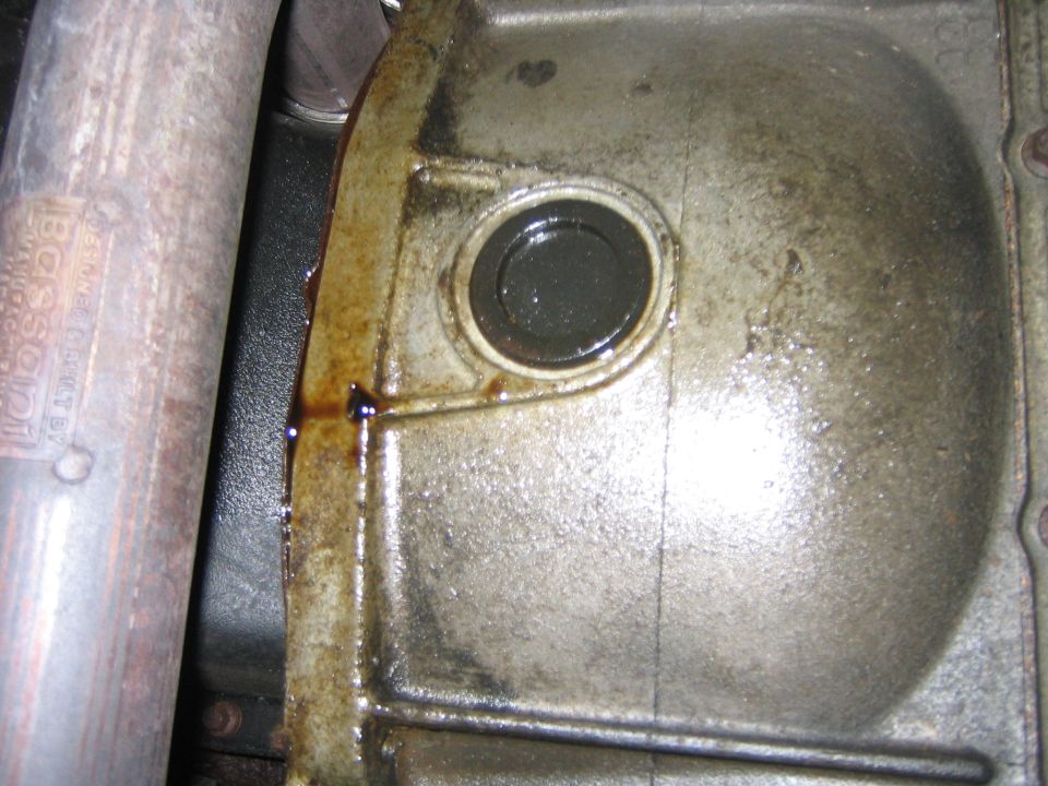 This write up is for changing the rear main oil seal.  As you can see mine was leaking, not all that bad, but I had the time.  This is not a project for the faint of heart, mainly because you have to remove the tranny.  Mine being an E4OD it was plenty big and heavy.  Yes you have to remove the tranny, I tried a trick one of my friends who is a mechanic suggested and it didn’t work, and actually caused me more work.  I learned many things and made several bad mistakes, I will go over them and hopefully by reading this you will not make them.

Ah yes, the wonderful oil drip.