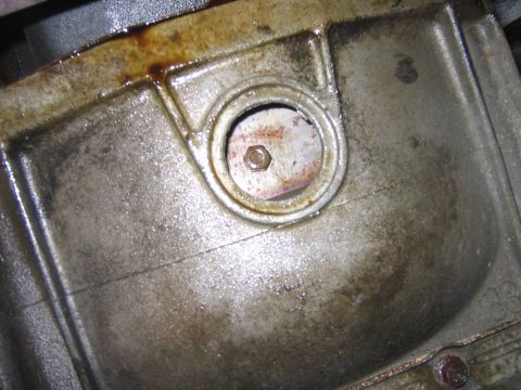 1995 Ford Bronco - Take off the little plastic cover and rotate the engine until the drain screw is right here. I just stick a big socket on the main pulley o…