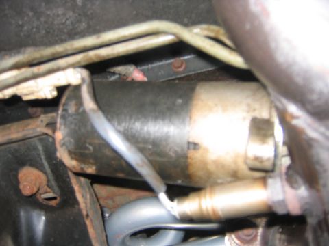 1995 Ford Bronco - Now unbolt the starter, you can just set it on the exhaust or something, just as long as it doesn’t hang by the wires.