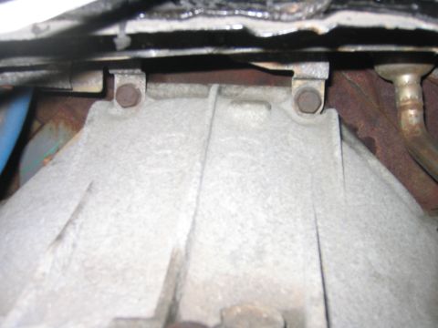1995 Ford Bronco - By taking the cover off you get access to these 2 bolts which hold the tranny to the engine. I guess you don’t have to take the cover off,…