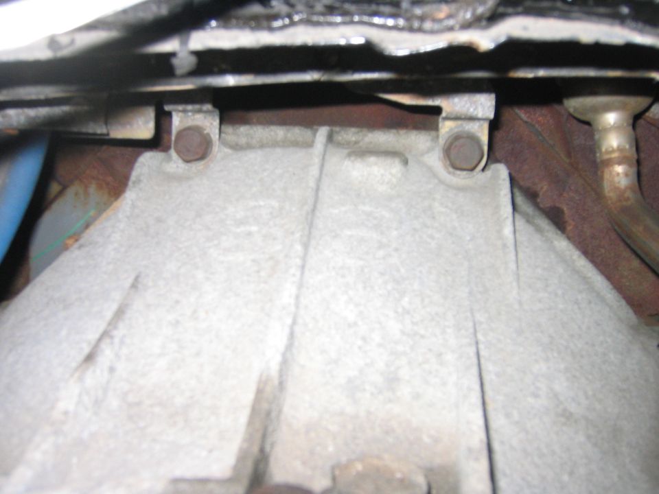 By taking the cover off you get access to these 2 bolts which hold the tranny to the engine.  I guess you don’t have to take the cover off, but it would be a royal pain to get these off.  You also get easy access to the upper tranny cooler line