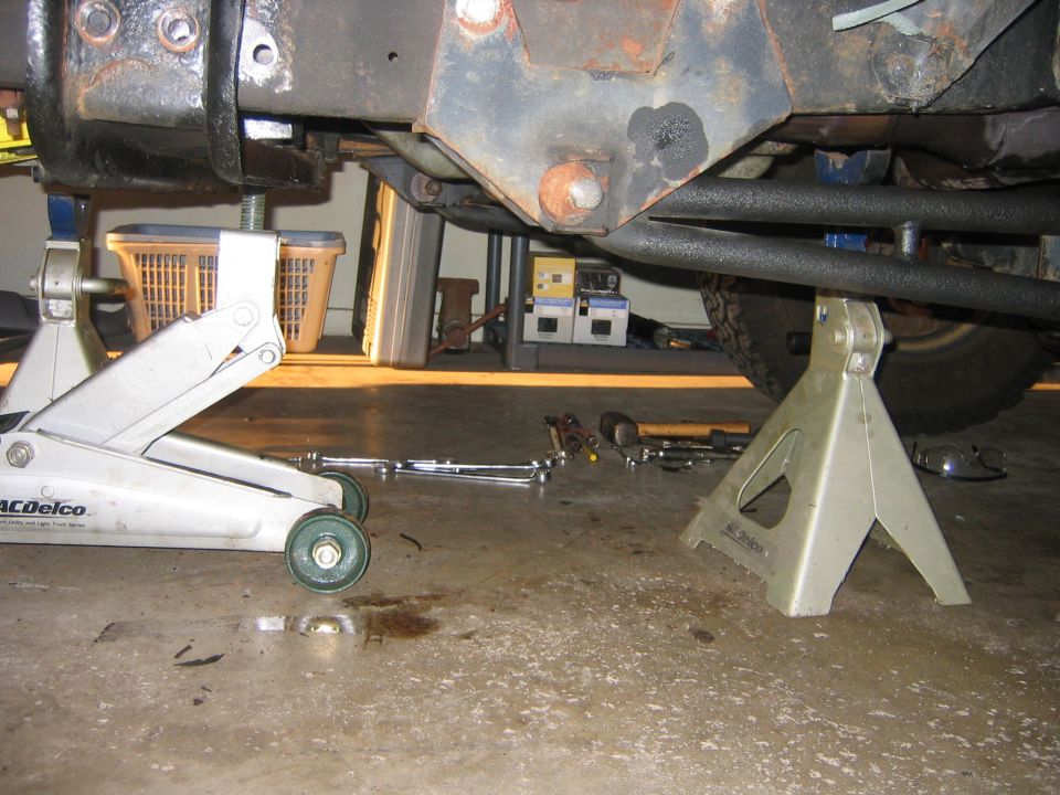 At this point I was taking the tranny out for the first time using a method I DO NOT recommend, I will show it to you guys just for learning sake, and maybe some of you will make it work but this began a long chain of screw ups so watch and learn.  At this point I supported the tranny with my floor jack.