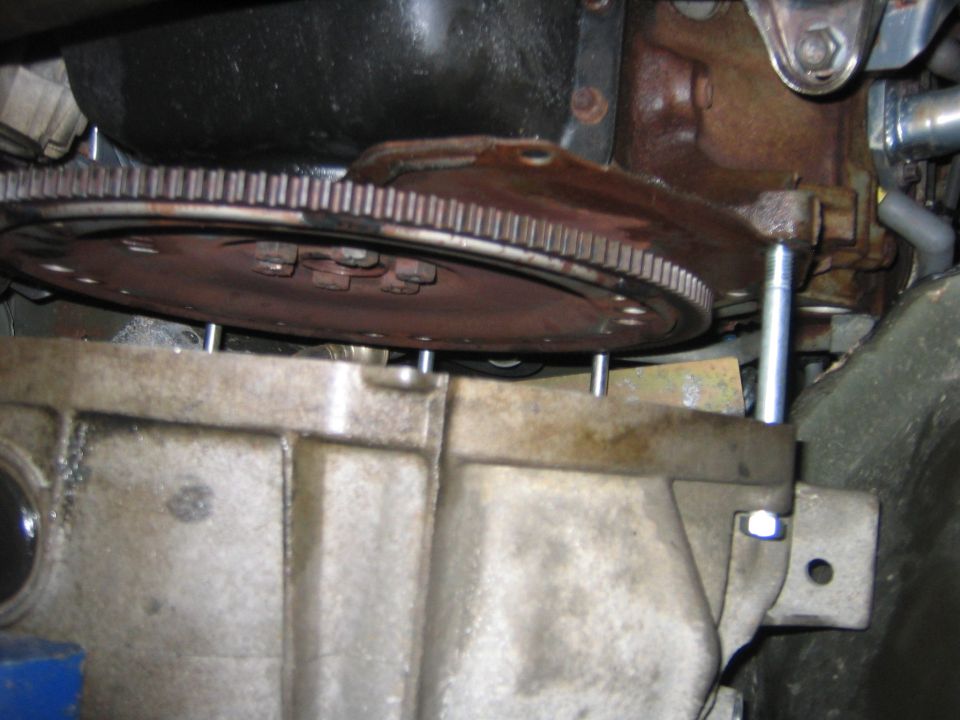 Now it wasn’t easy to pull the tranny this far back, I ended up using a ratcheting strap, it was a big ordeal.  But now you have access to the fly wheel.