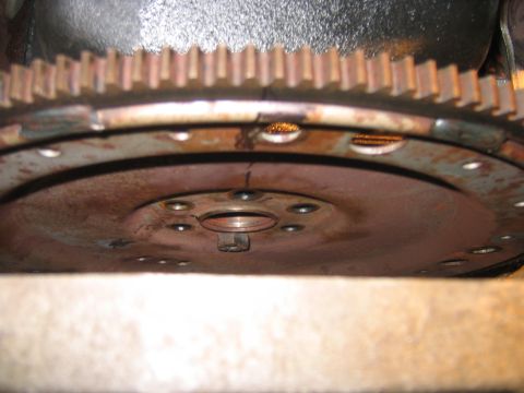1995 Ford Bronco - Take all the bolts out accept one and then loosen it slowly until it comes off, make sure you have a good hold on the fly wheel before the…