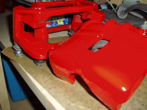 1993 Ford Taurus - Red brake calipers are shown, possibly for an upgrade, with some text visible in the background.