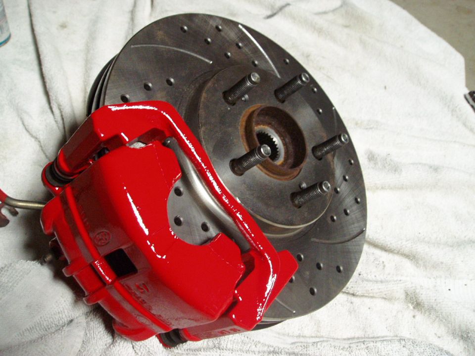 Red brake caliper and drilled rotor