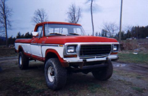 1979 Ford F-250 - This red and white 1979 Ford F-250 pickup truck is shown from a 3/4 front angle.