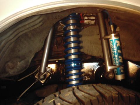 1978 Ford Bronco - Close-up of the rear suspension system, a blue coilover shock and King Off-Road Racing shocks.