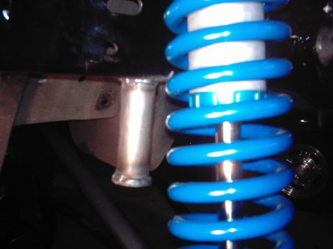 1978 Ford Bronco - Blue coilover shock absorber assembly, likely part of a suspension upgrade.