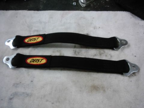 1978 Ford Bronco - A pair of black Deist racing straps with silver mounting hardware are displayed on a textured surface.