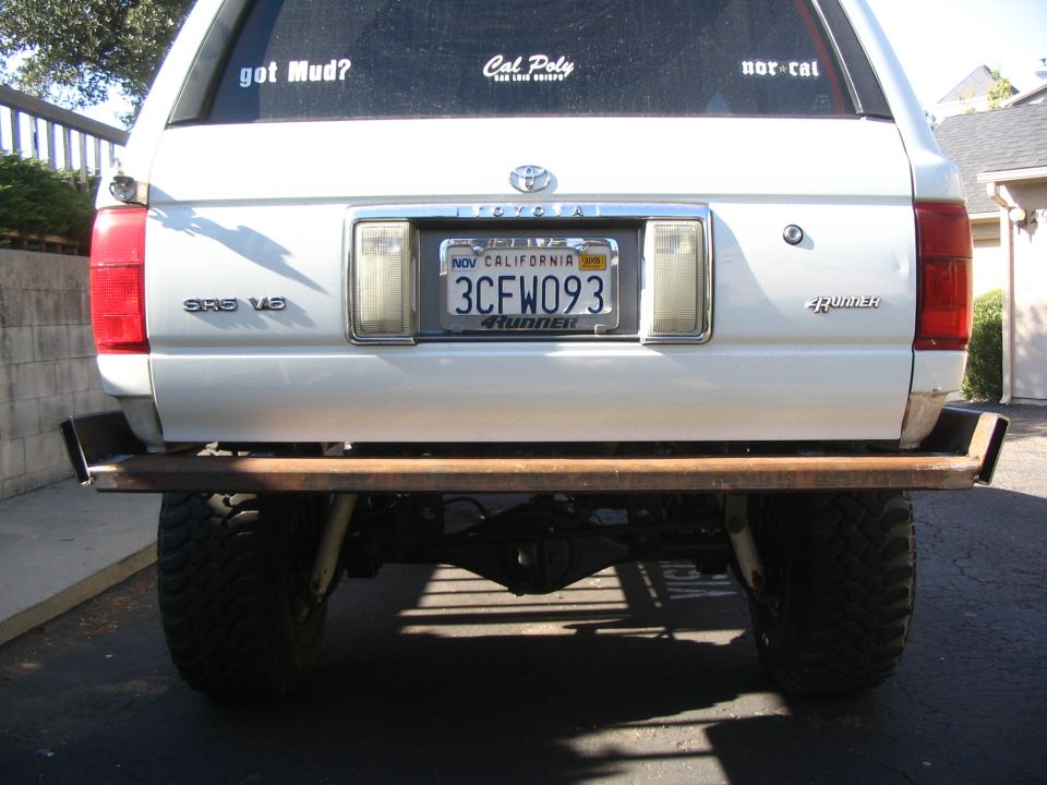 Rear of silver Toyota 4Runner SR5 V6 with custom bumper, California plate 3CFW093, sticker decals