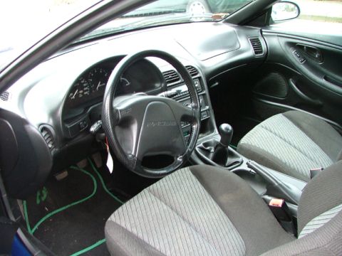 1994 Ford Probe - The interior of a 1994 Ford Probe, showing the dashboard, steering wheel, and seats.