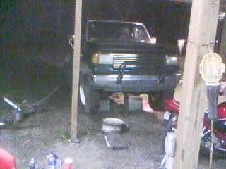 1986 Ford Bronco - Front view of a 1986 Ford Bronco parked under a wooden structure.