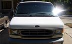 1999 Ford E150 - Front view of a white 1999 Ford E150 van parked outdoors.