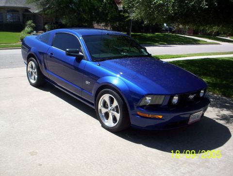 2005 Ford Mustang - 2005 Ford Mustang GT in blue, parked in a driveway.