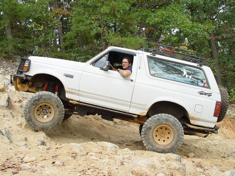 1996 Ford Bronco - A white 1996 Ford Bronco navigates a rocky off-road course.
